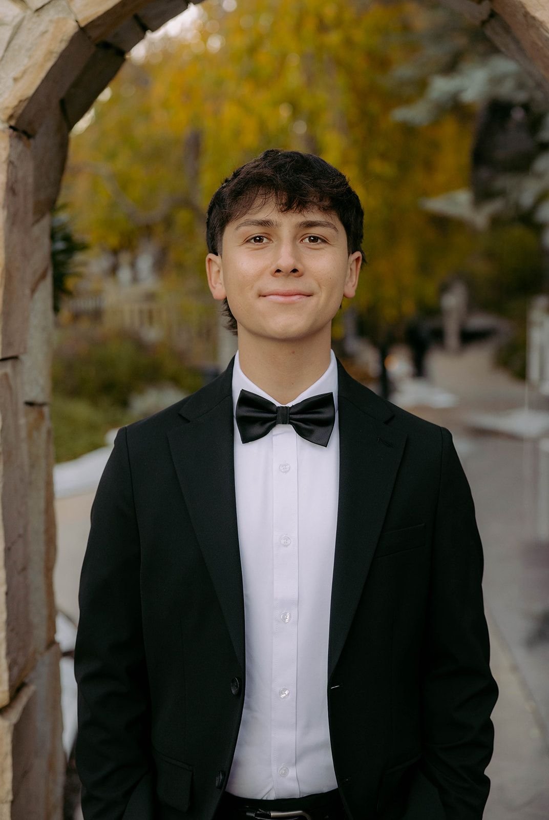Emilio Alomía in a black suit and bow tie