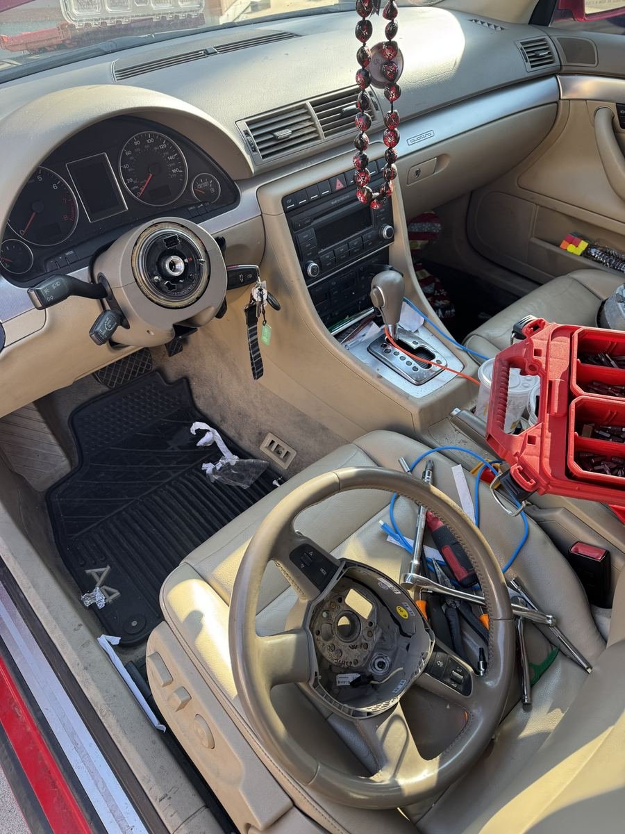 Car interior with the steering wheel removed for a repair